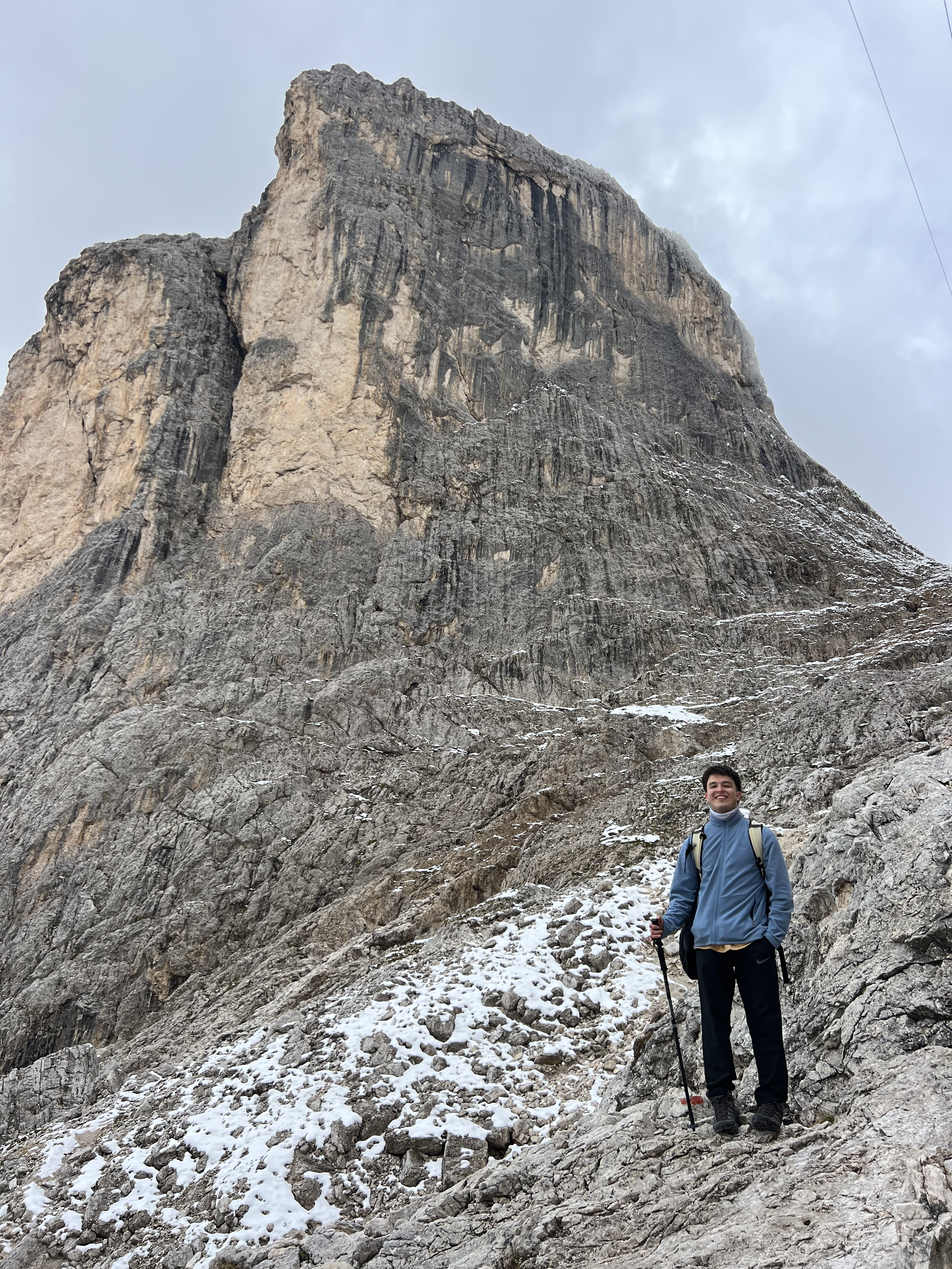 Hiking under a massive rock face